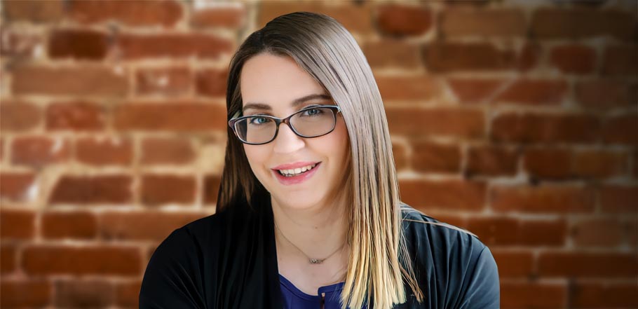 professional portrait of a smiling woman with straight brown hair