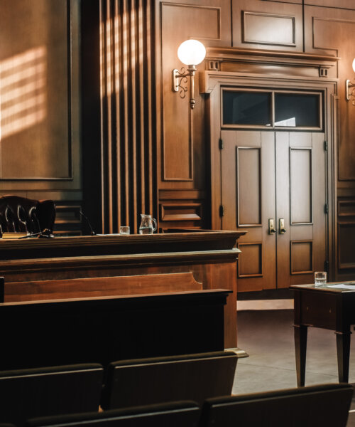 well-lit, empty courtroom with wooden paneling