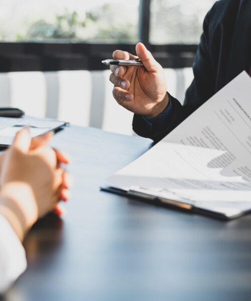 Two professionals reviewing paperwork