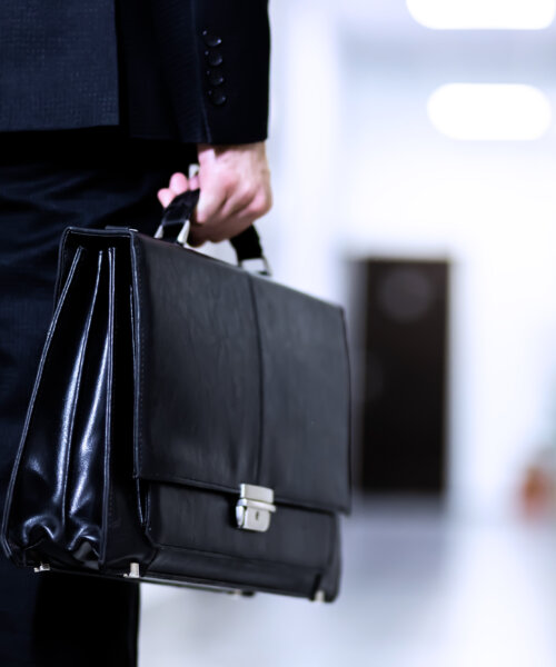 Unrecognizable Businessman holding a briefcase walking